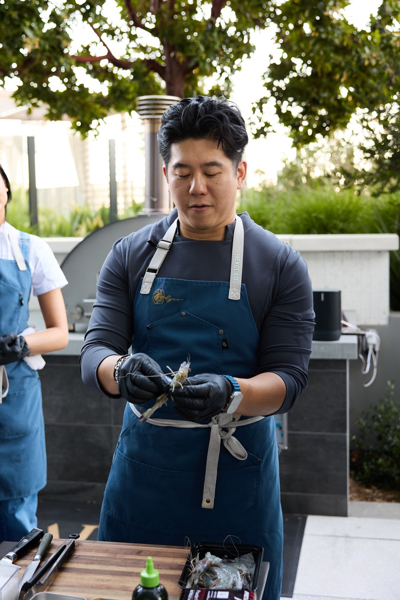 Chef Jasper Lynn preparing seafood during a cooking class