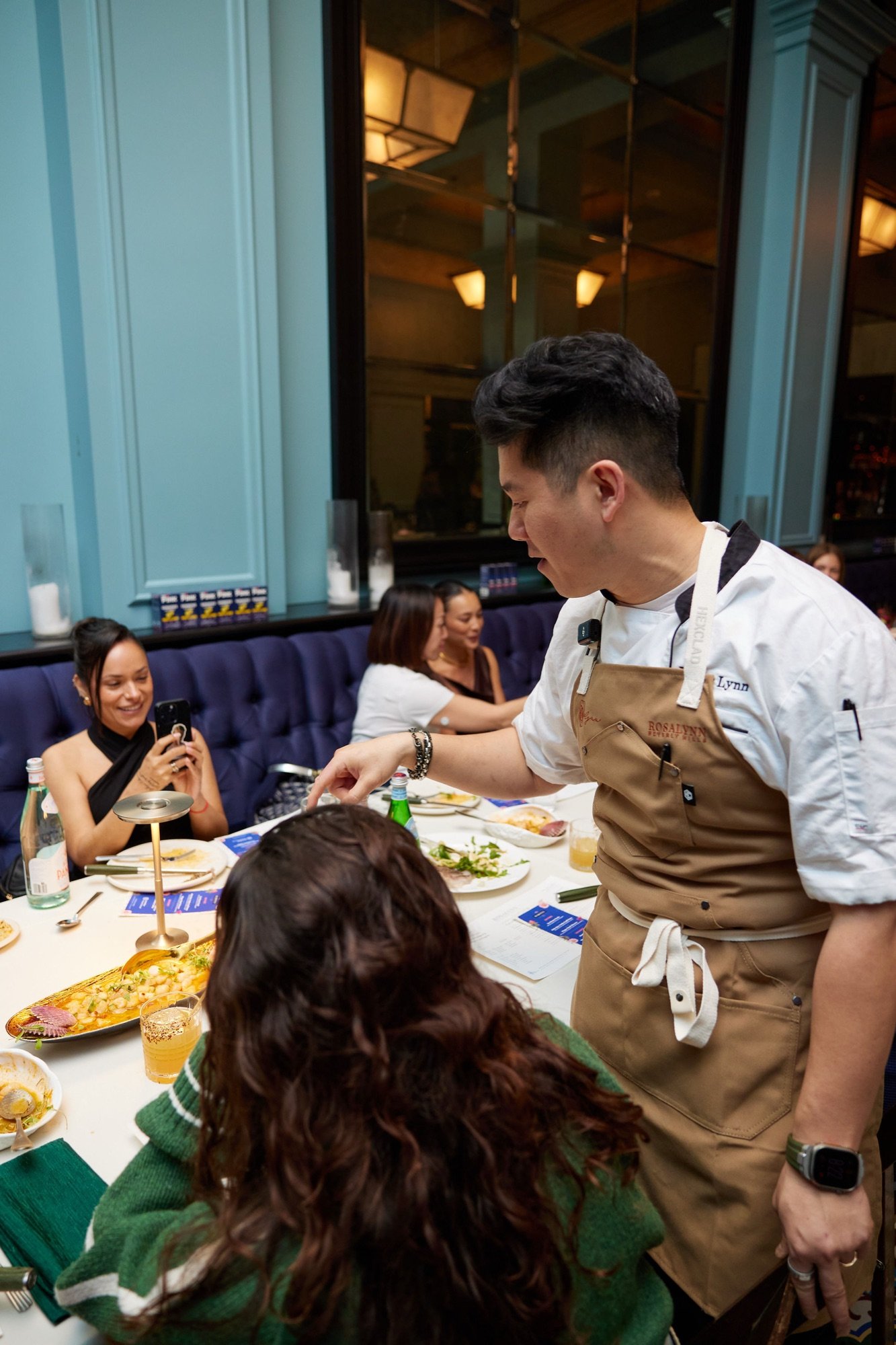 Chef Jasper Lynn plating tableside at a Rosalynn dinner